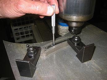  Using a small bore adjustable feeler gage to check the slot width. Tricky things to use because you have to hold them perpendicular to the part in two axis (l-r and front-back) and rotate it between your fingers, also judging by feel the amount of 'drag' the gage has on the part. Then you measure the gage with outside micrometers, going for the same amount of drag to get your reading.  I still have some practicing to do before I can repeatably read it like Bill can.